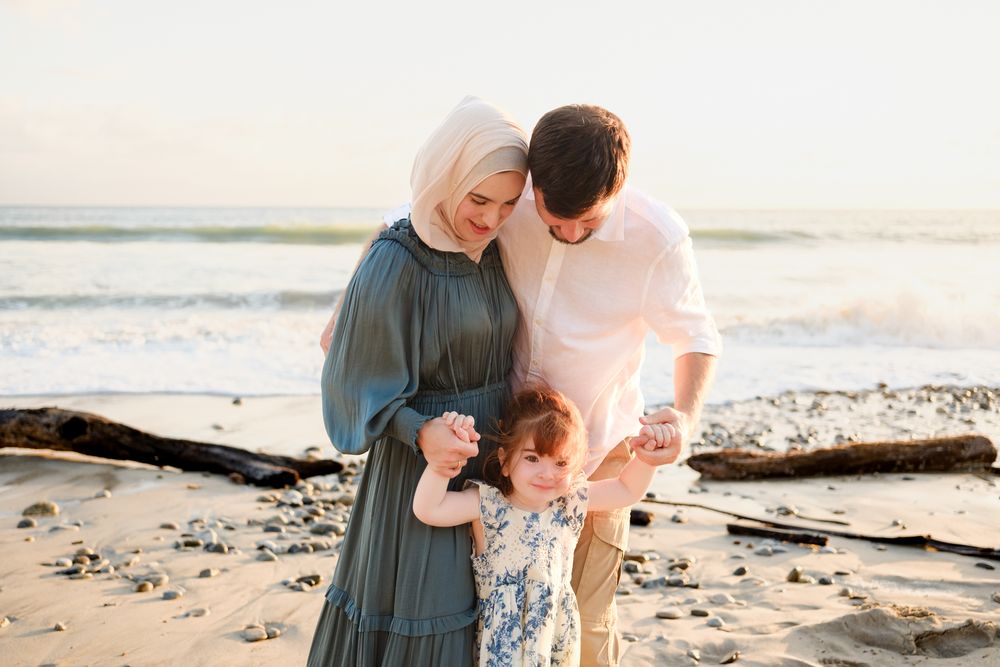 Punta Mita family photographer captures a family sharing an intimate moment during a sunset family photo session on the beach.