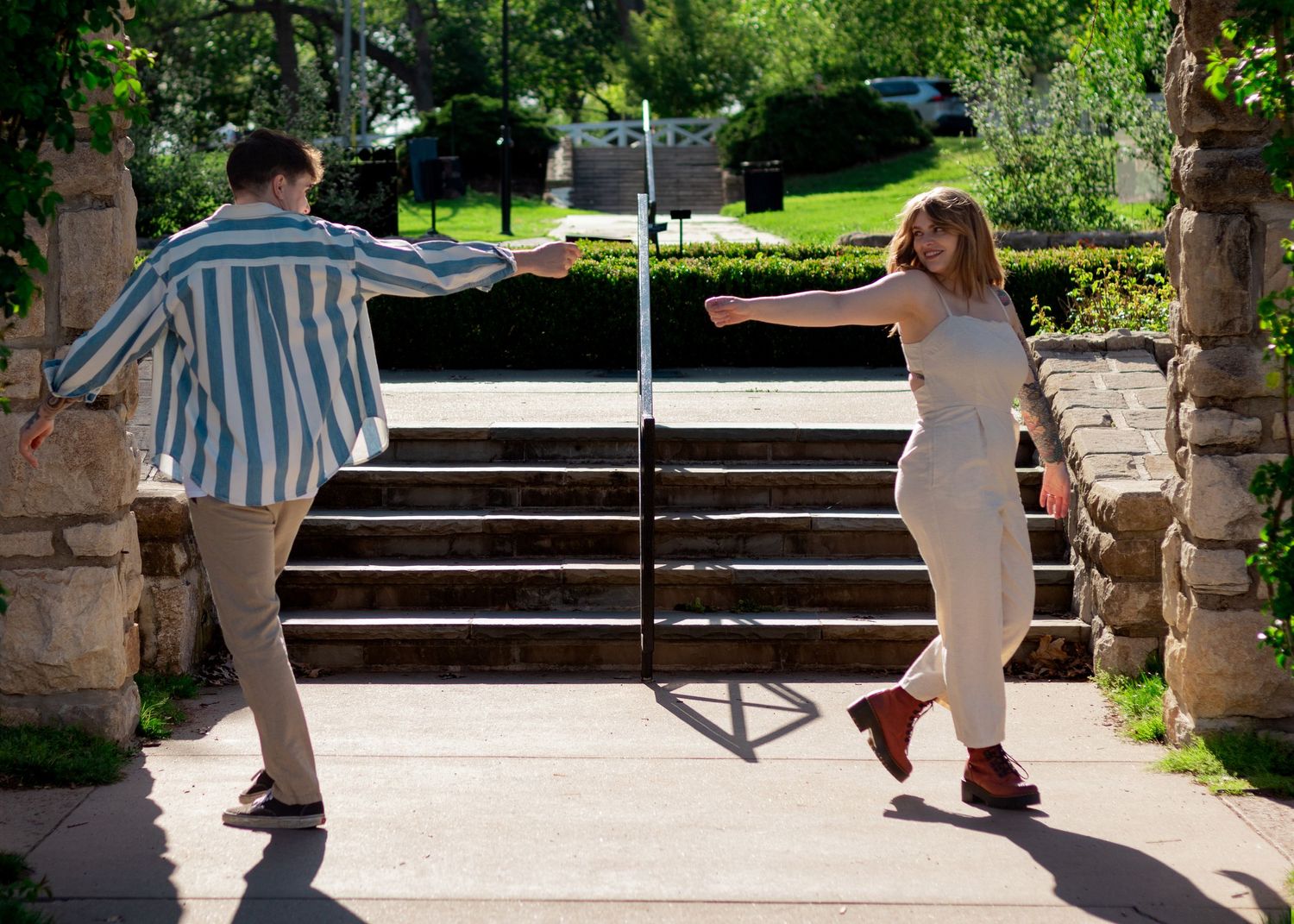 Couple walking past each other reaching out to grab hands