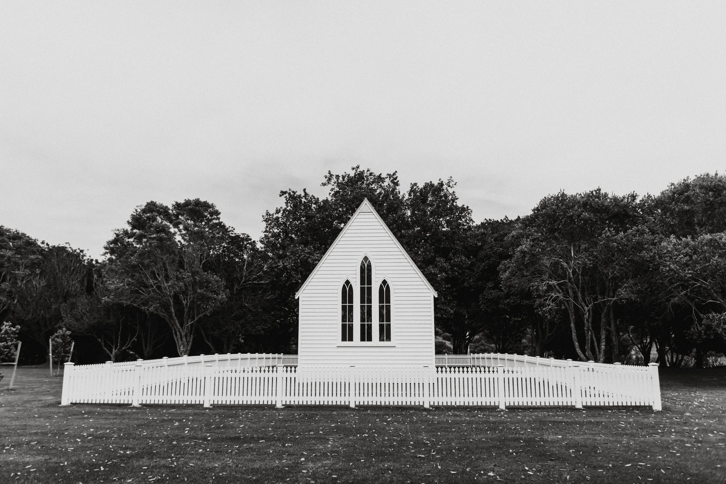 A horizontal series of black and white landscape photographs showing a white church steeple and rural countryside scenes.