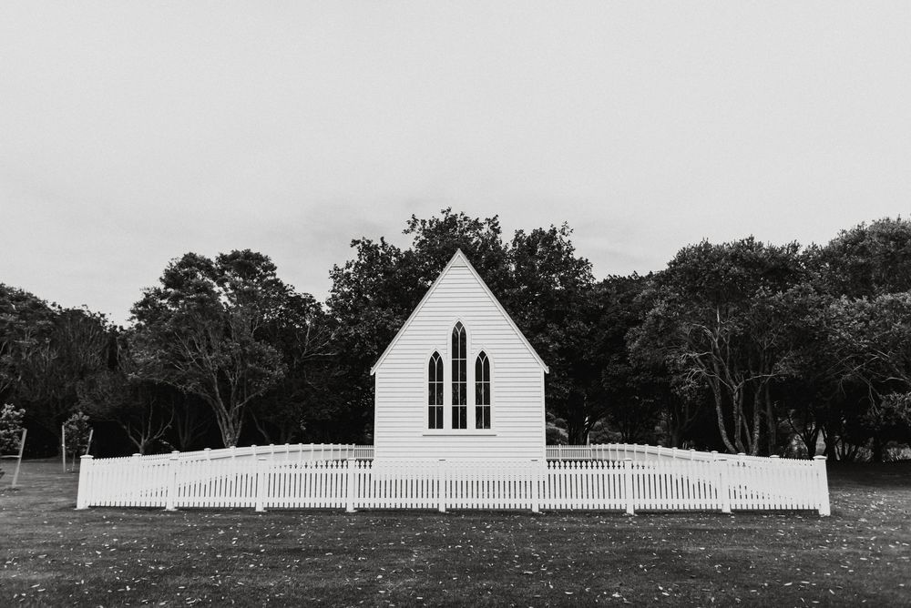 A horizontal series of black and white landscape photographs showing a white church steeple and rural countryside scenes.