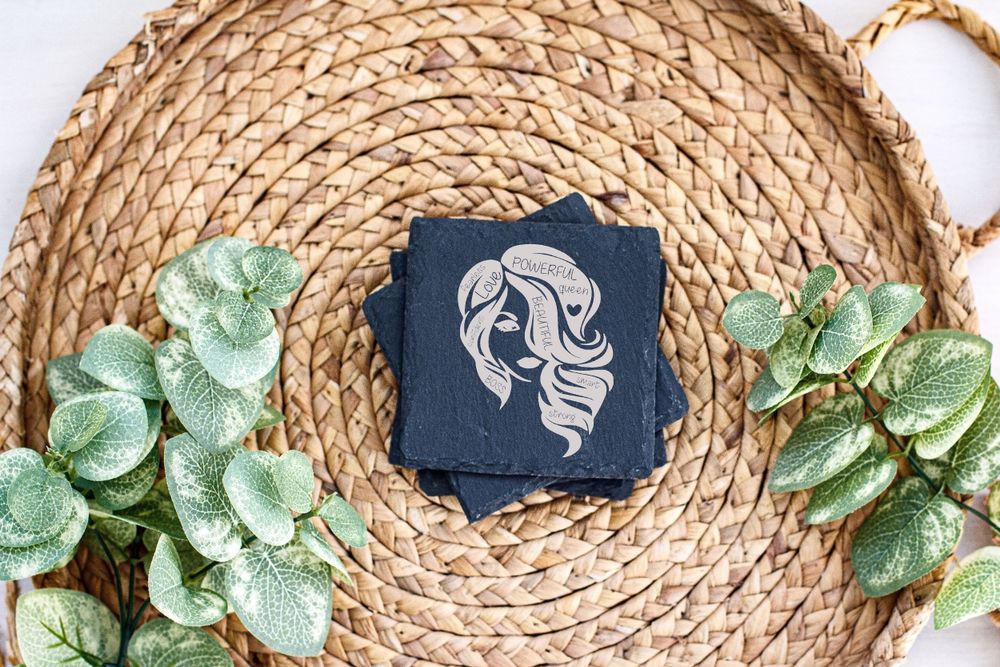 Navy blue card with animal design displayed on woven rattan charger with faux eucalyptus leaves.