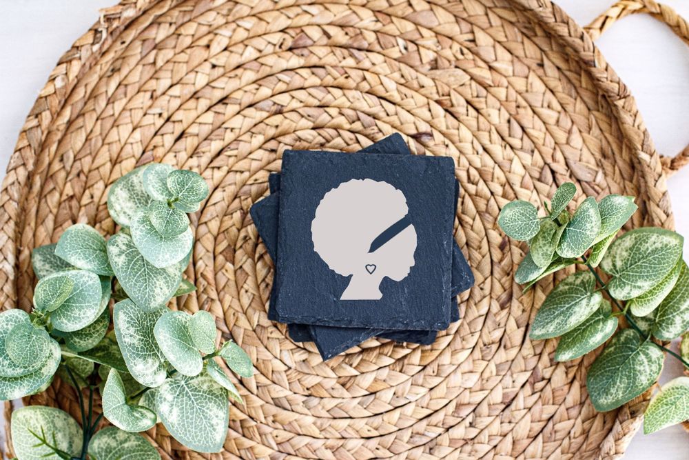 Decorative card with profile silhouette displayed on circular woven placemat with green foliage.