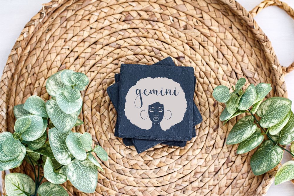 Silhouette design card displayed on round woven placemat with green leaf decor.