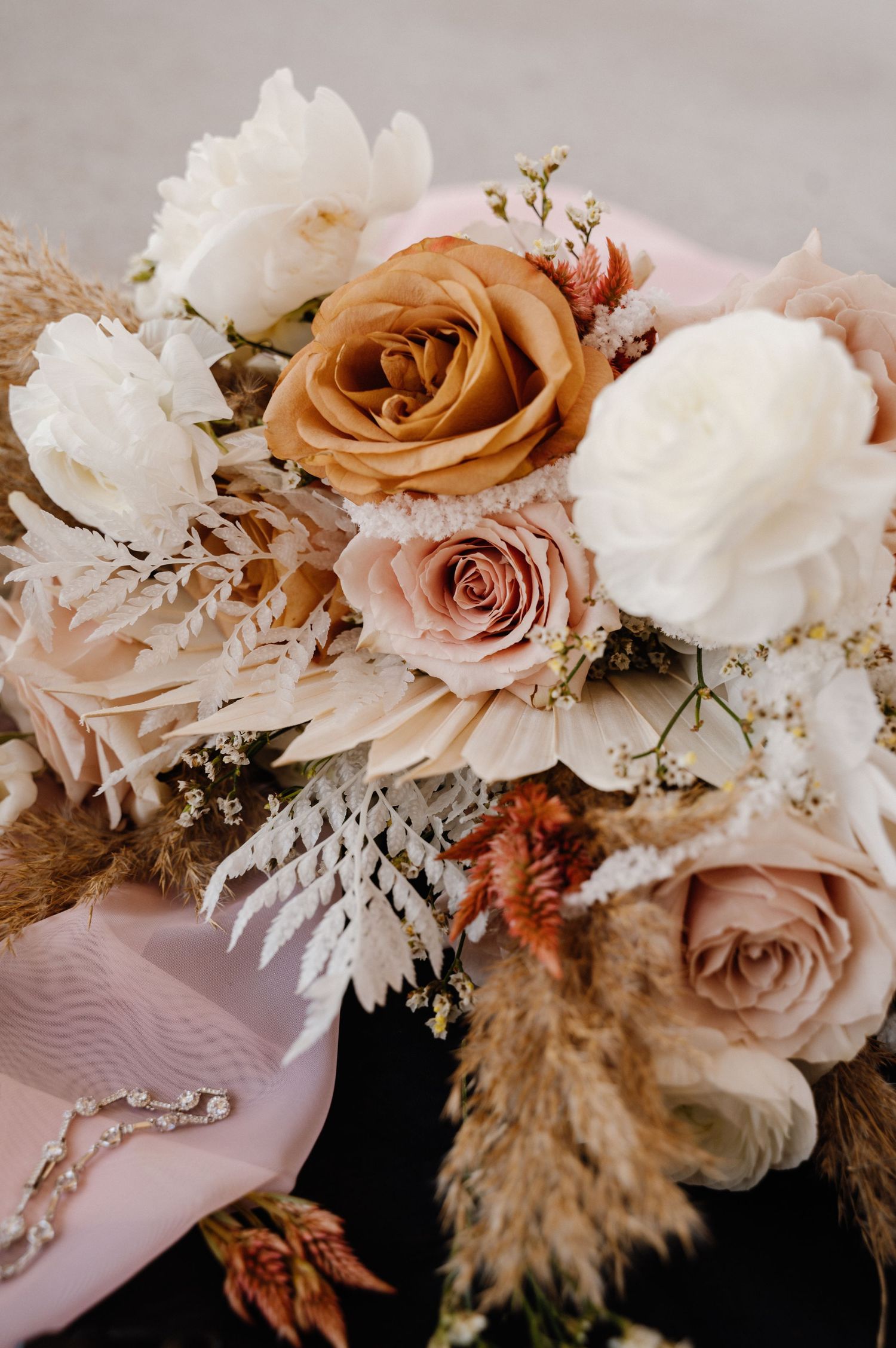 Romantic neutral-toned wedding bouquet with roses, dried flowers and pampas grass. Oklahoma Wedding Photographer