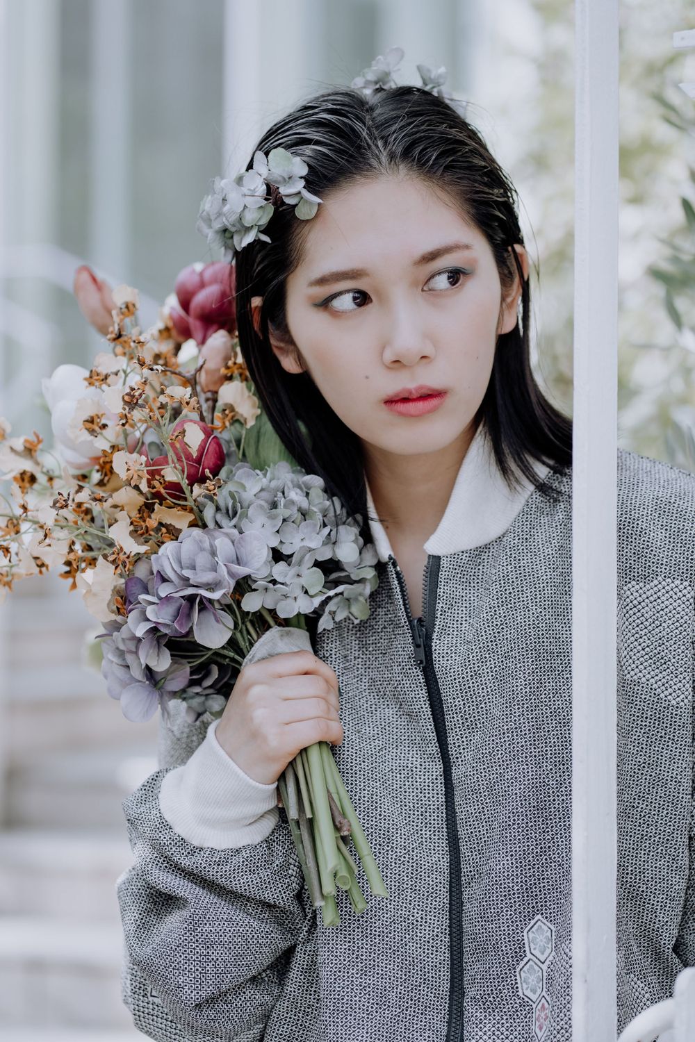 Asian girl holding a flower arrangement