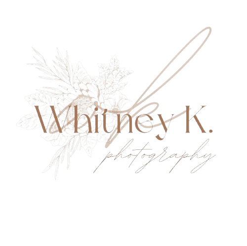 A white decorative photography logo with floral elements and elegant script text.