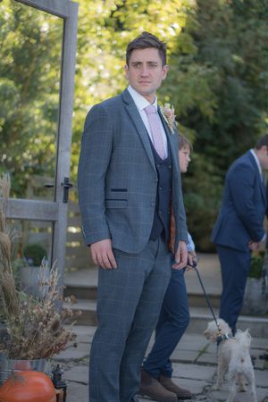 A groom stood at the end of the aisle waiting for his bride to arrive.