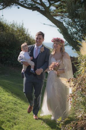 A newly wed bride and groom just before they walk through a confetti run