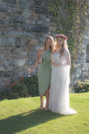 A bride is stood with one of her wedding guests.