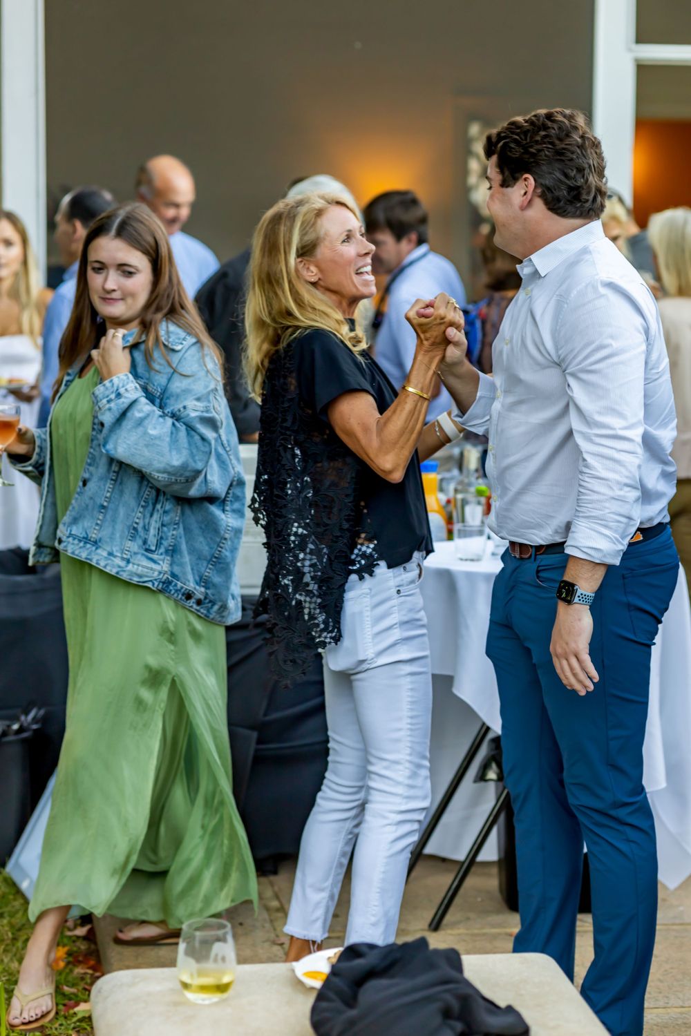 People mingling and dancing at casual outdoor social event.