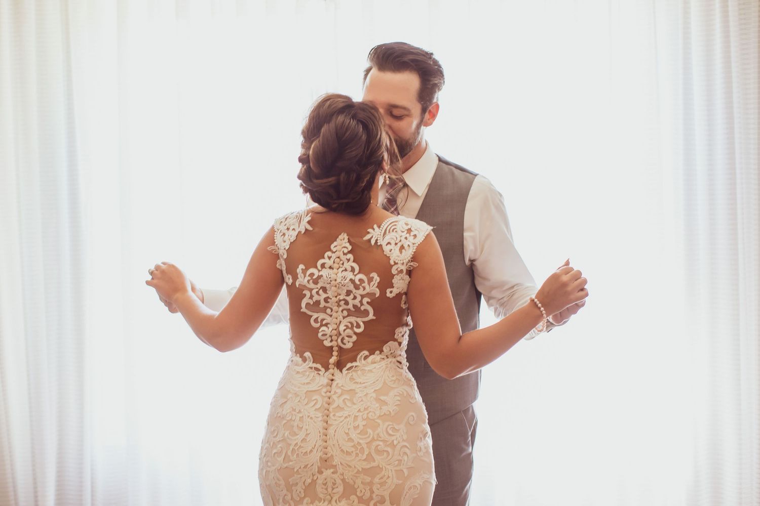 A romantic first dance moment captured at an indoor wedding venue.