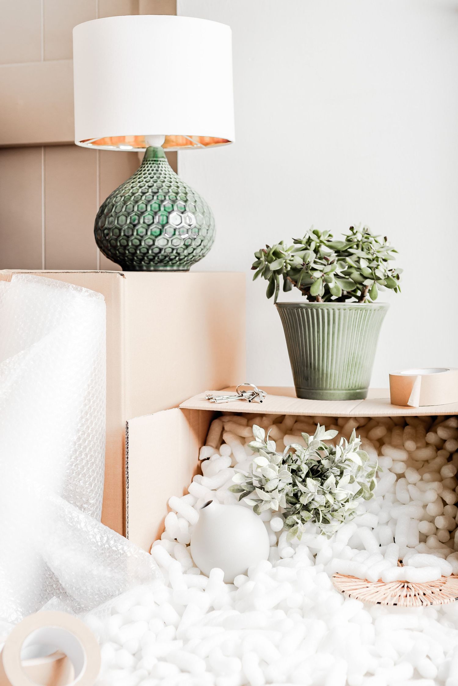 moving boxes with packing peanuts and lamp unpacked. moving home, new home, renovation, stock photos