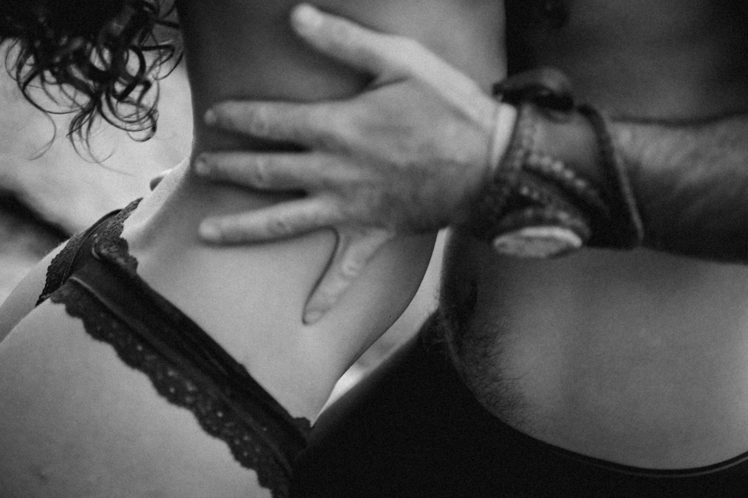 Artistic black and white photograph capturing intimate moment with lace details.