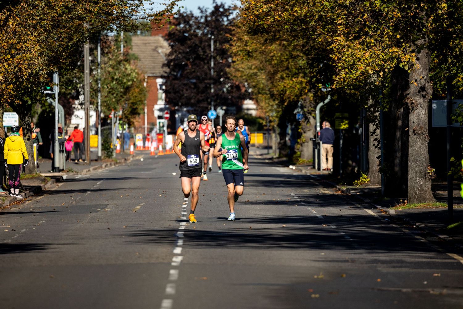 Two runners captured running down a road in Peterborough for the Great Eastern Run