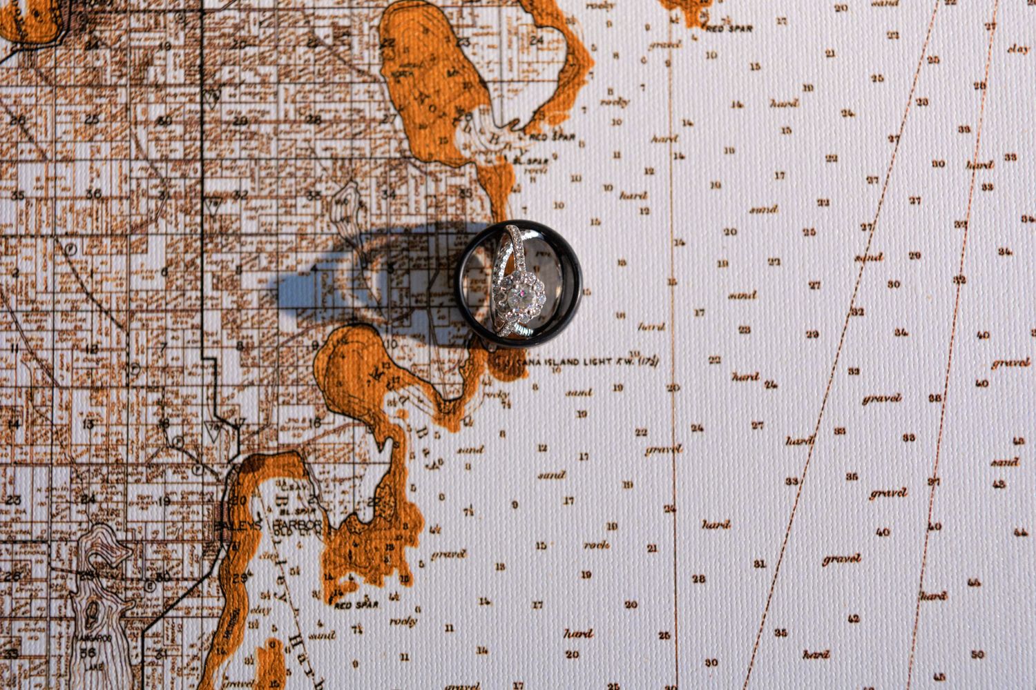 Vintage compass on old nautical map with orange toned land features.