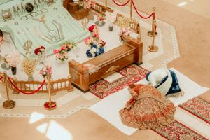High angle view of traditional Sikh wedding ceremony with ornate decorations and furnishings.