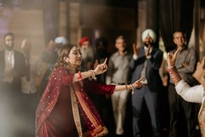 Guests in traditional attire dancing and celebrating at a cultural wedding reception.