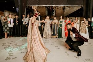 A couple performing a choreographed dance routine at their wedding reception.