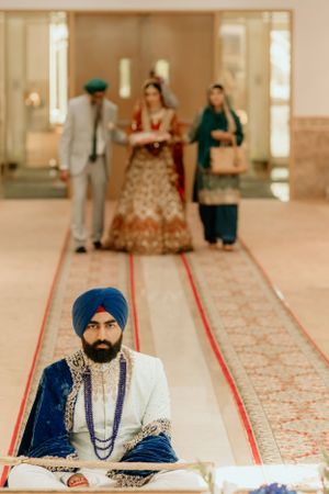 A Sikh wedding ceremony showing traditional ceremonial seating arrangements in a Gurdwara.