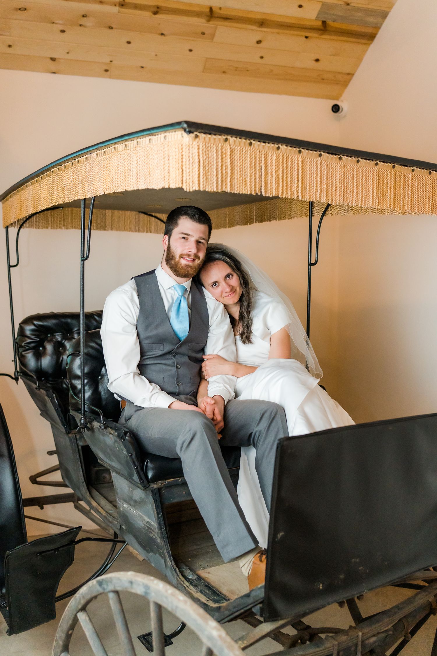 bride and groom sitting in the surrey