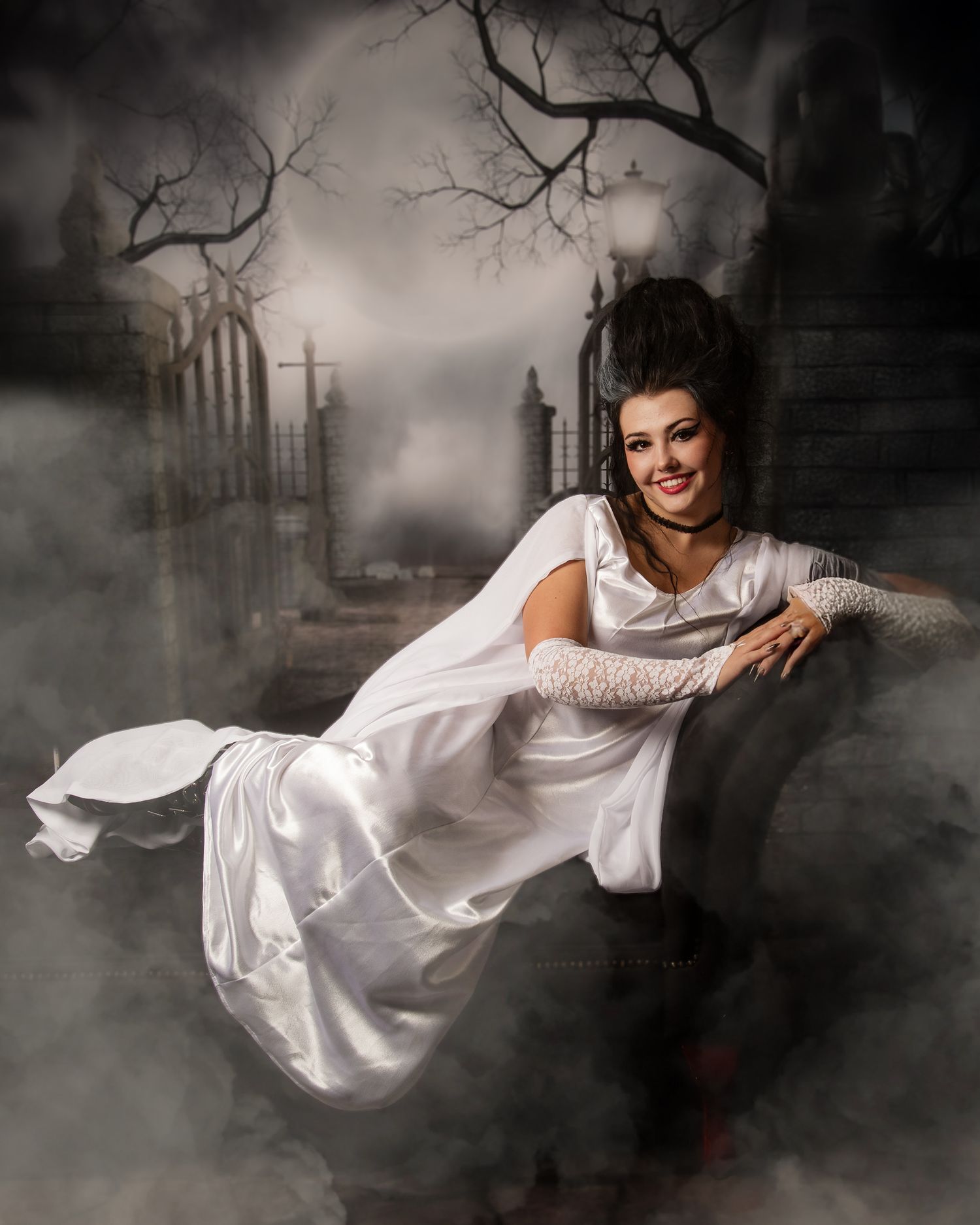 Unicorn costume portrait in mystical graveyard setting with fog and mood lighting.