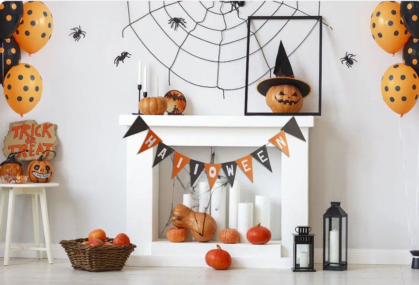Halloween themed photoshoot with pumpkins and gothic arches in orange and black tones.