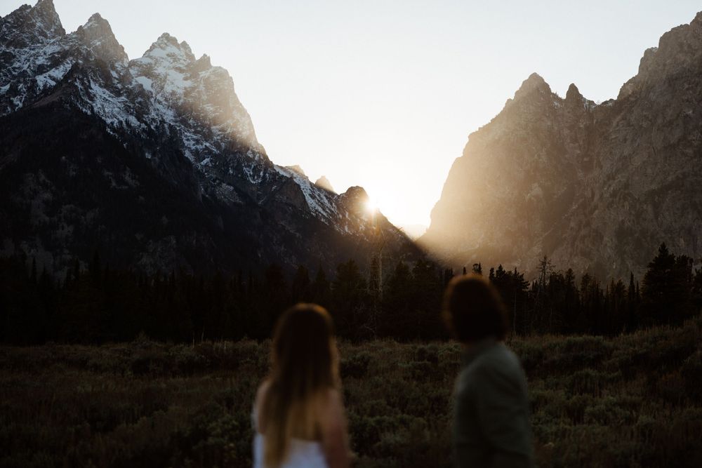 Majestic mountain silhouettes at sunset with dramatic lighting in Grand Teton National Park.