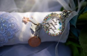Close-up detail shot of delicate lace wedding dress embellishments.