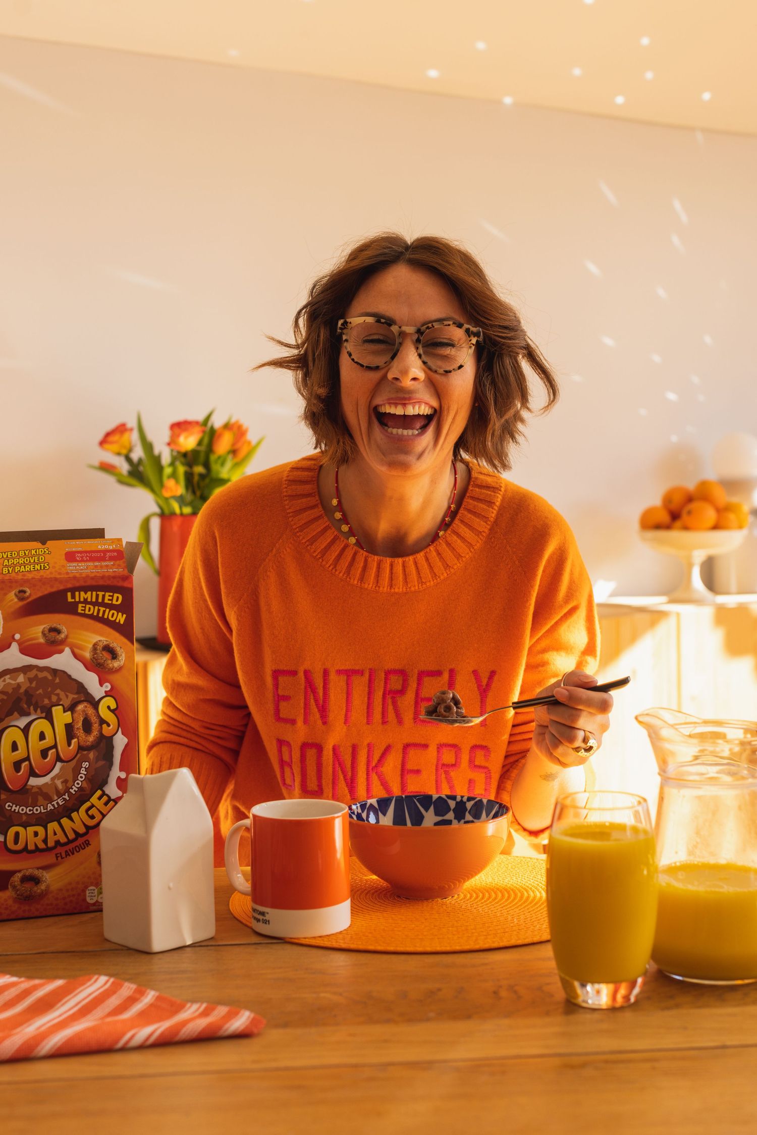 Sussex influencer model laughing over a bowl of Weetos for Instagram content, warm toned to match the product placement.