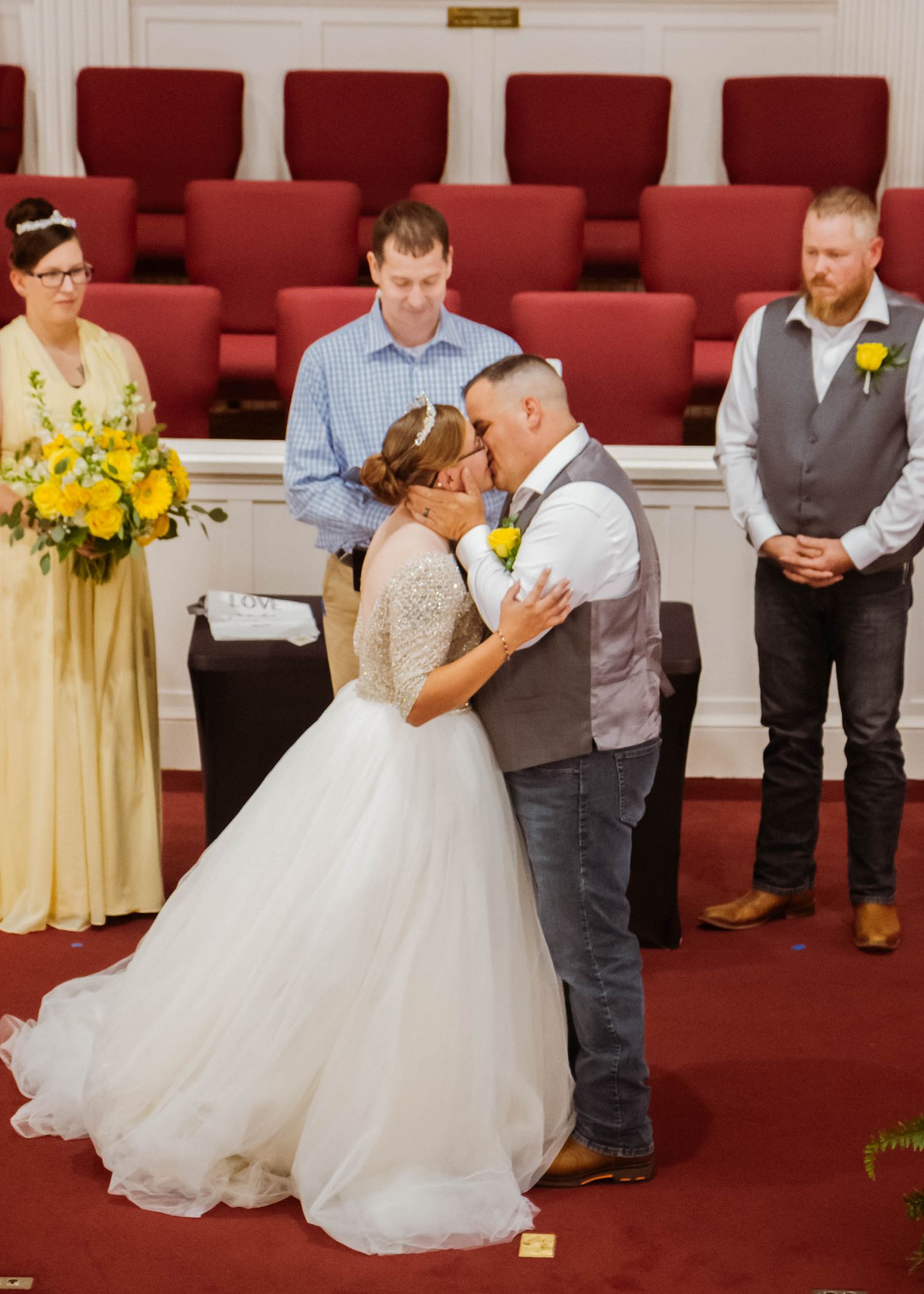 Romantic wedding ceremony in church with bride and groom sharing intimate moment.