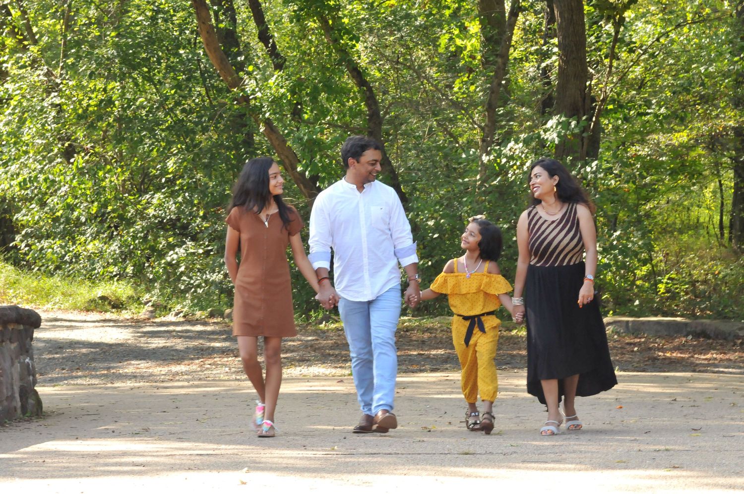 Family walking holding hands along Stone Bridge Centerville VA