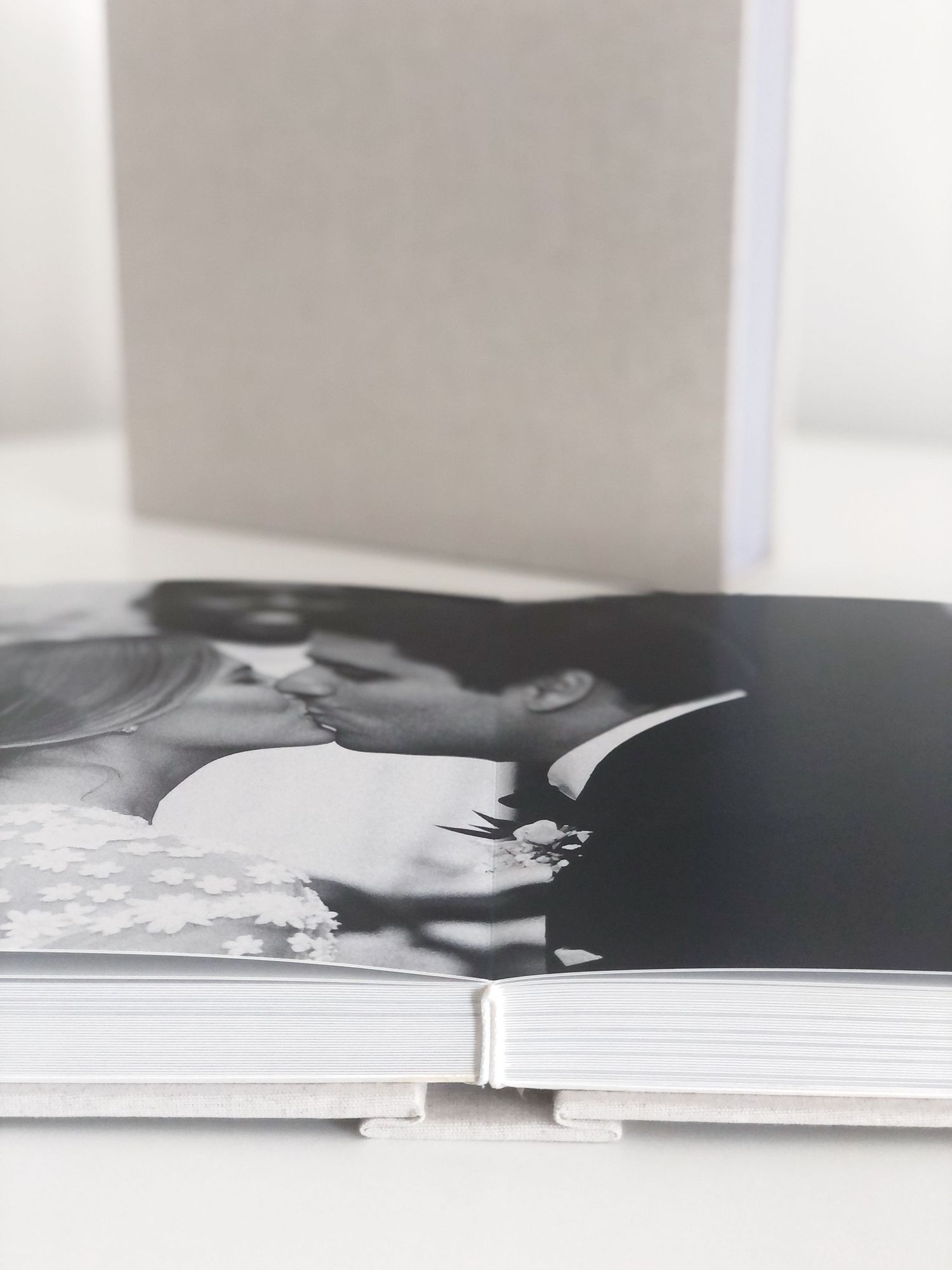 Black and white wedding photo album spread showing professional binding detail.