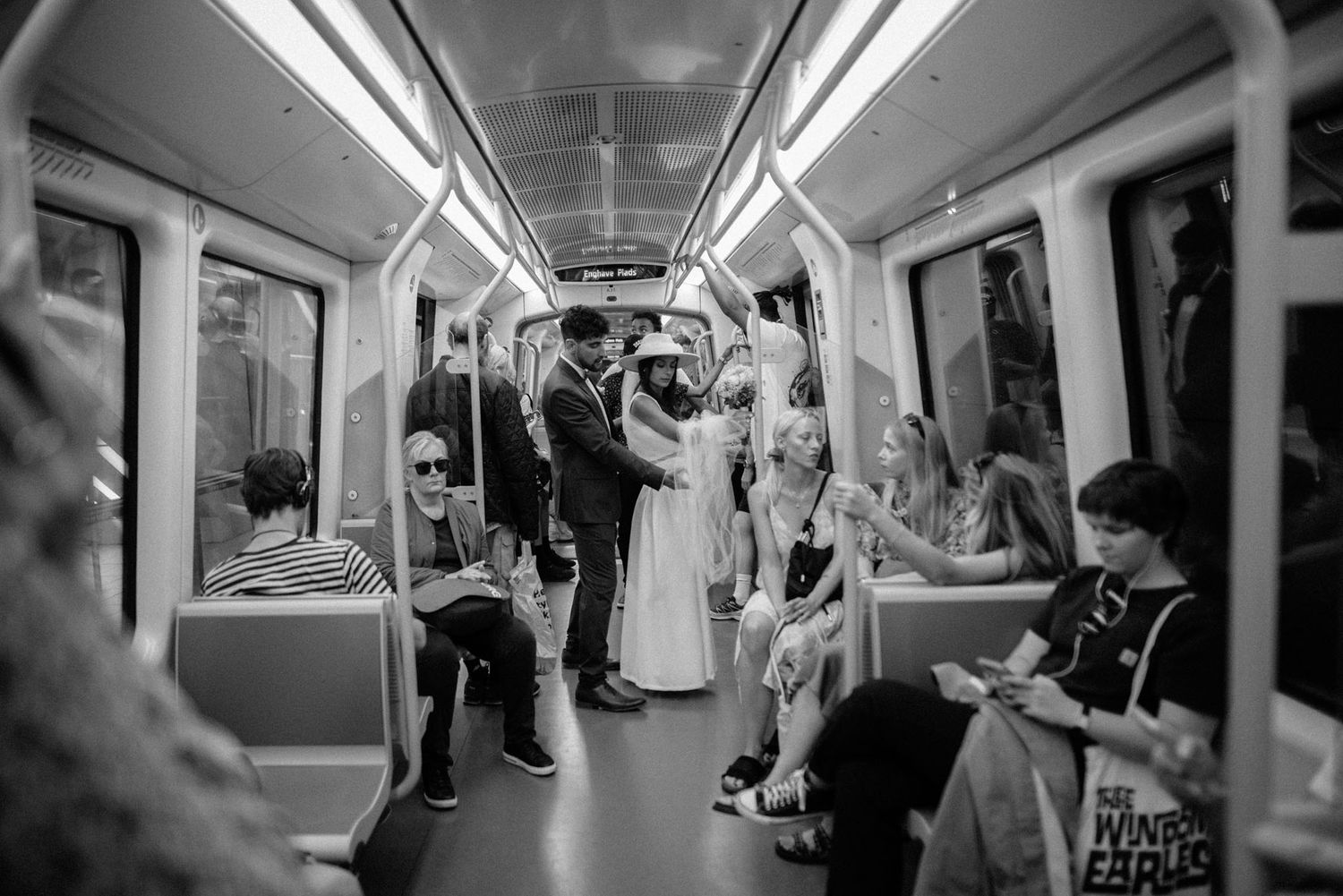 A couple on their wedding day posing on the metro in Copenhagen