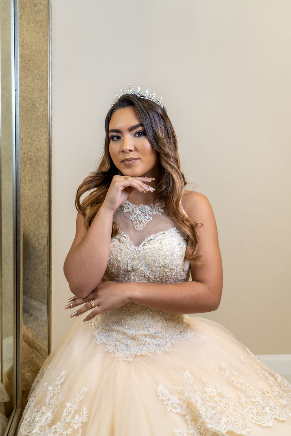 Elegant ball gown with lace bodice and tiara photographed in natural light.