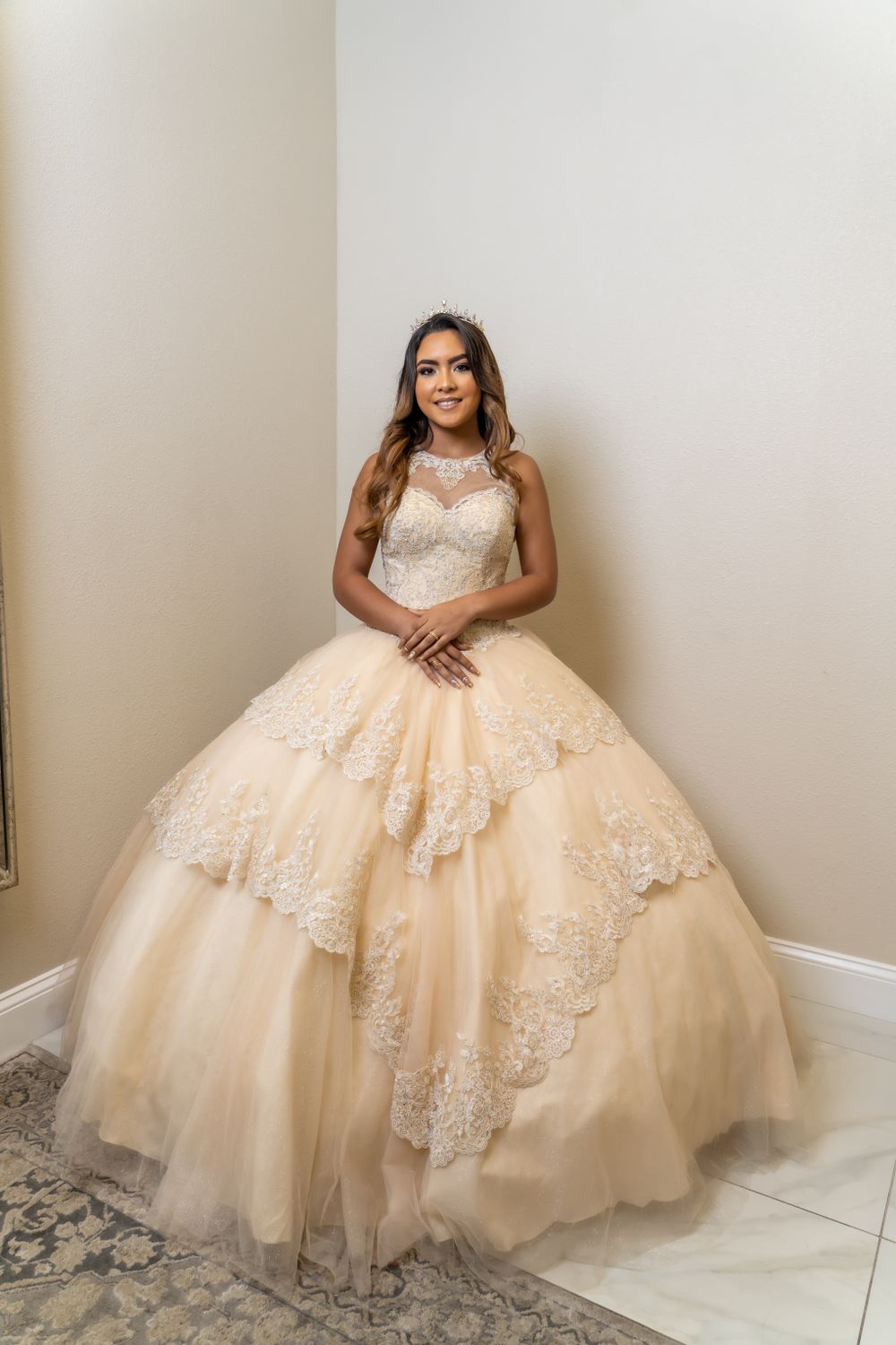 Champagne-colored ballgown with intricate lace layers and illusion neckline.