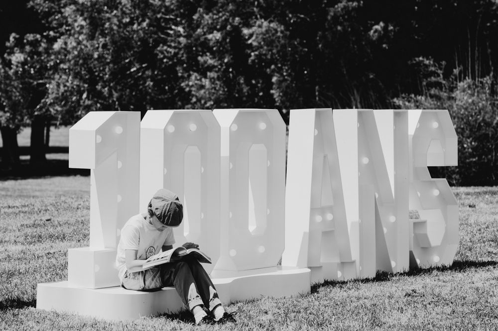 Black and white lettering or text display outdoors in daylight setting.