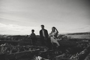 Artful family portrait of a family of four with a newborn girl in black and white.