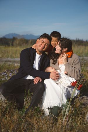 candid and playful moment during a documentary-style family newborn session at Iona Beach