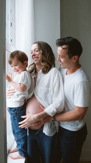 candid and natural moment during a family maternity photo session in a studio in Vancouver, BC
