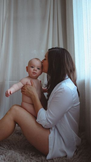 Intimate motherhood portrait session with six months old baby