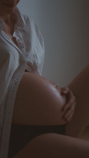 Intimate close-up of glowing pregnant belly