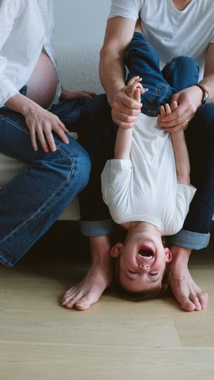 A toddler being playful during a family photoshoot.