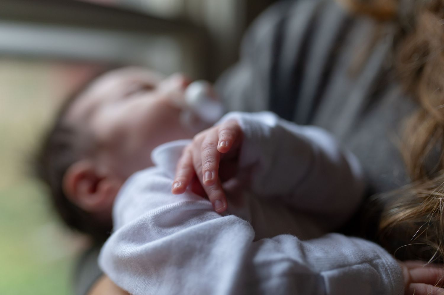Soft focus detail of newborn baby's tiny hand.