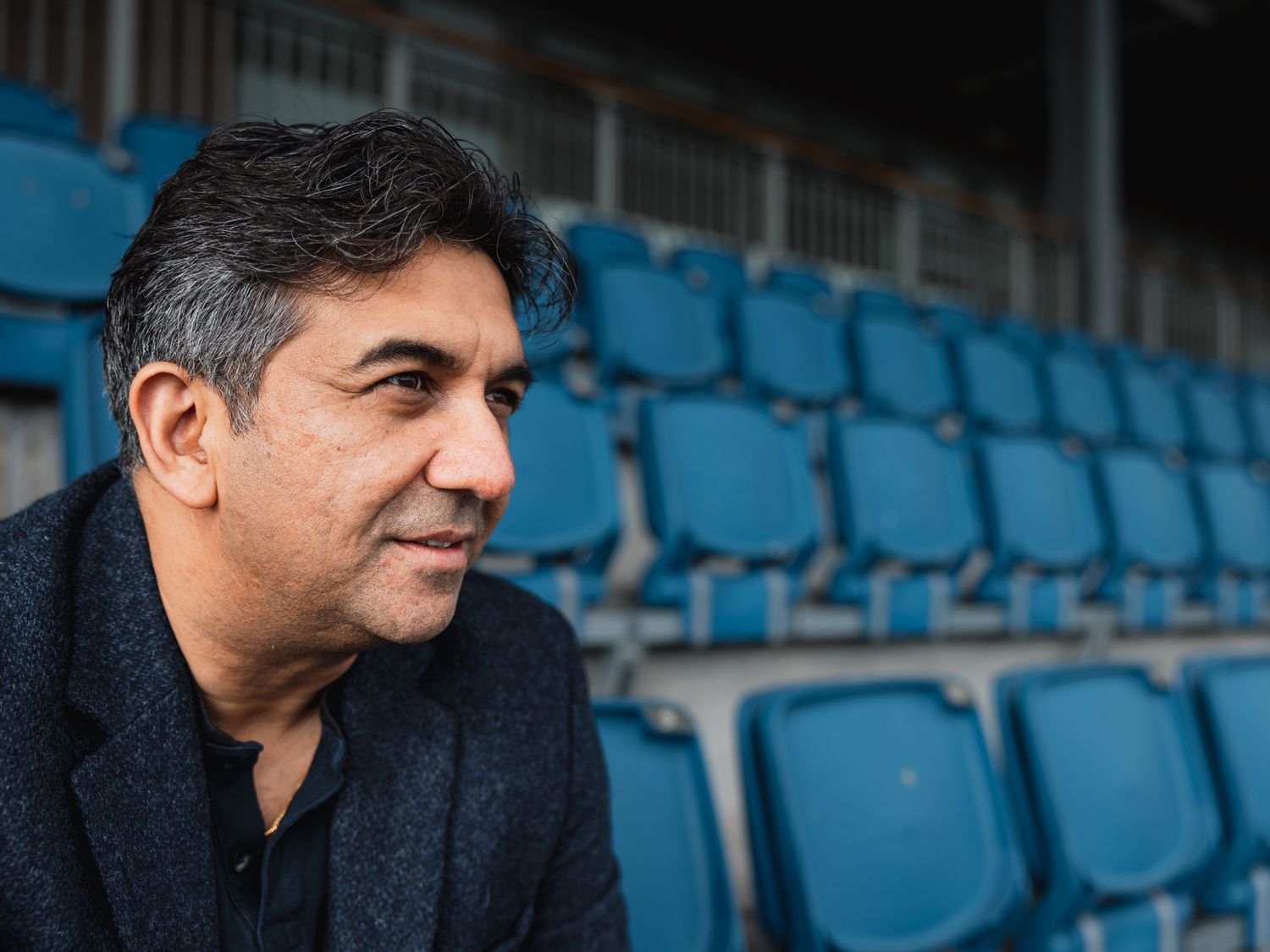 founder Indian man sitting in football stadium