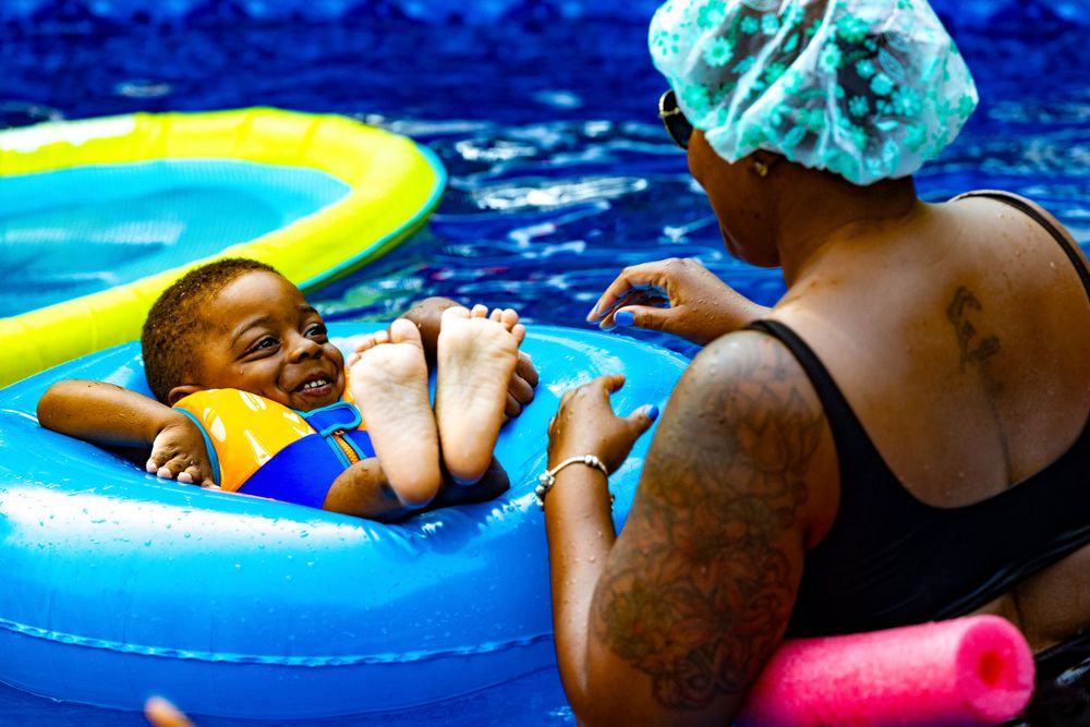 Fun summer pool party scene with colorful floats and swimming activities.