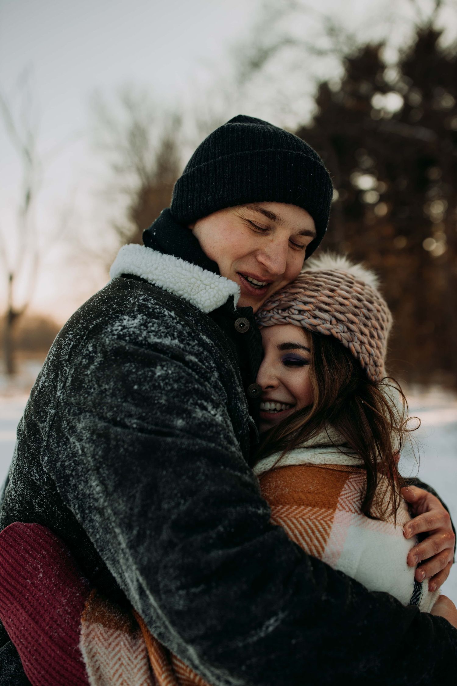 Couple-hugging-snow-engagement