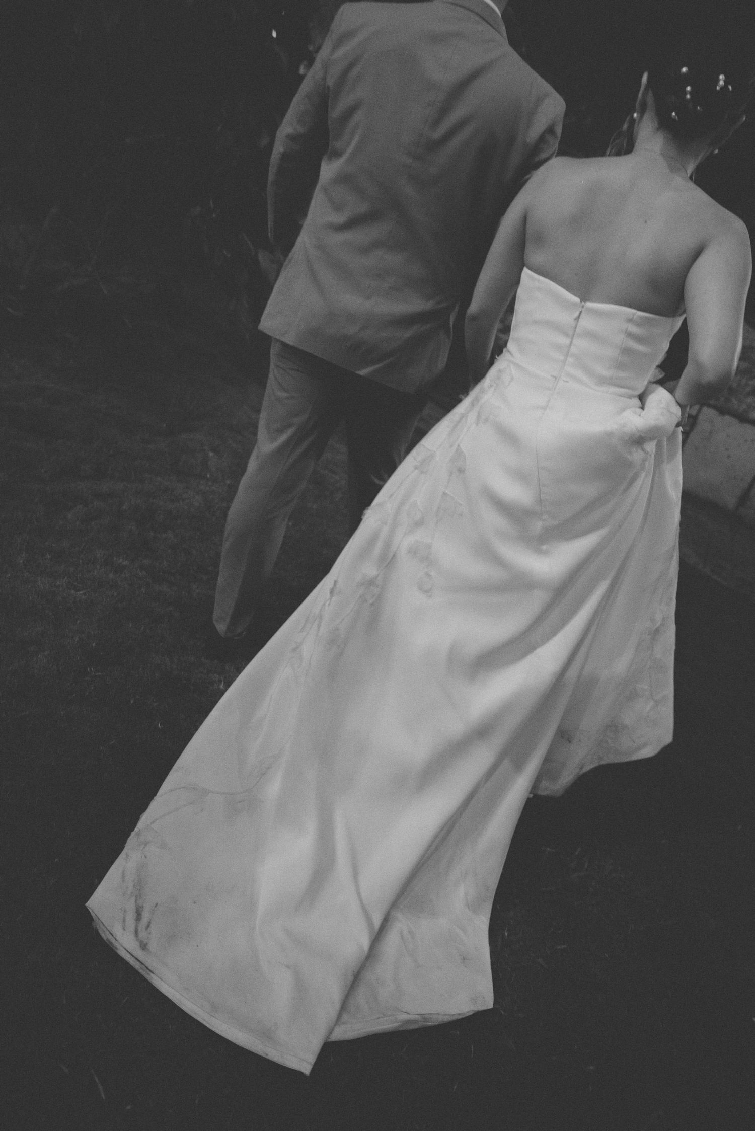 Black and white shot of flowing wedding dress train during reception dance.