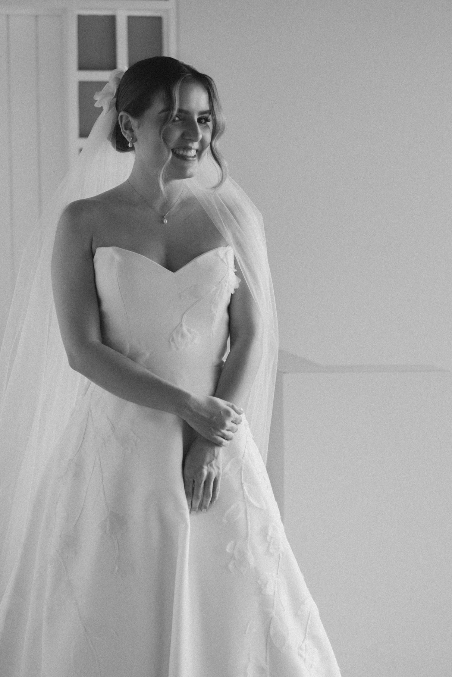 Classic bridal portrait in black and white featuring strapless wedding gown.