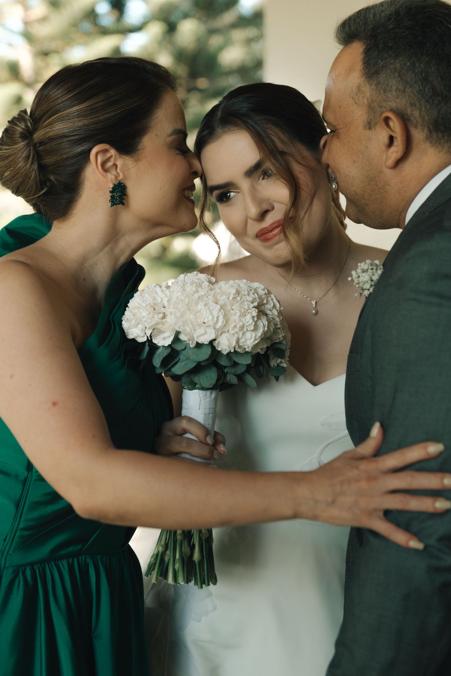 Intimate wedding moment shared between guests and the bride with white bouquet.