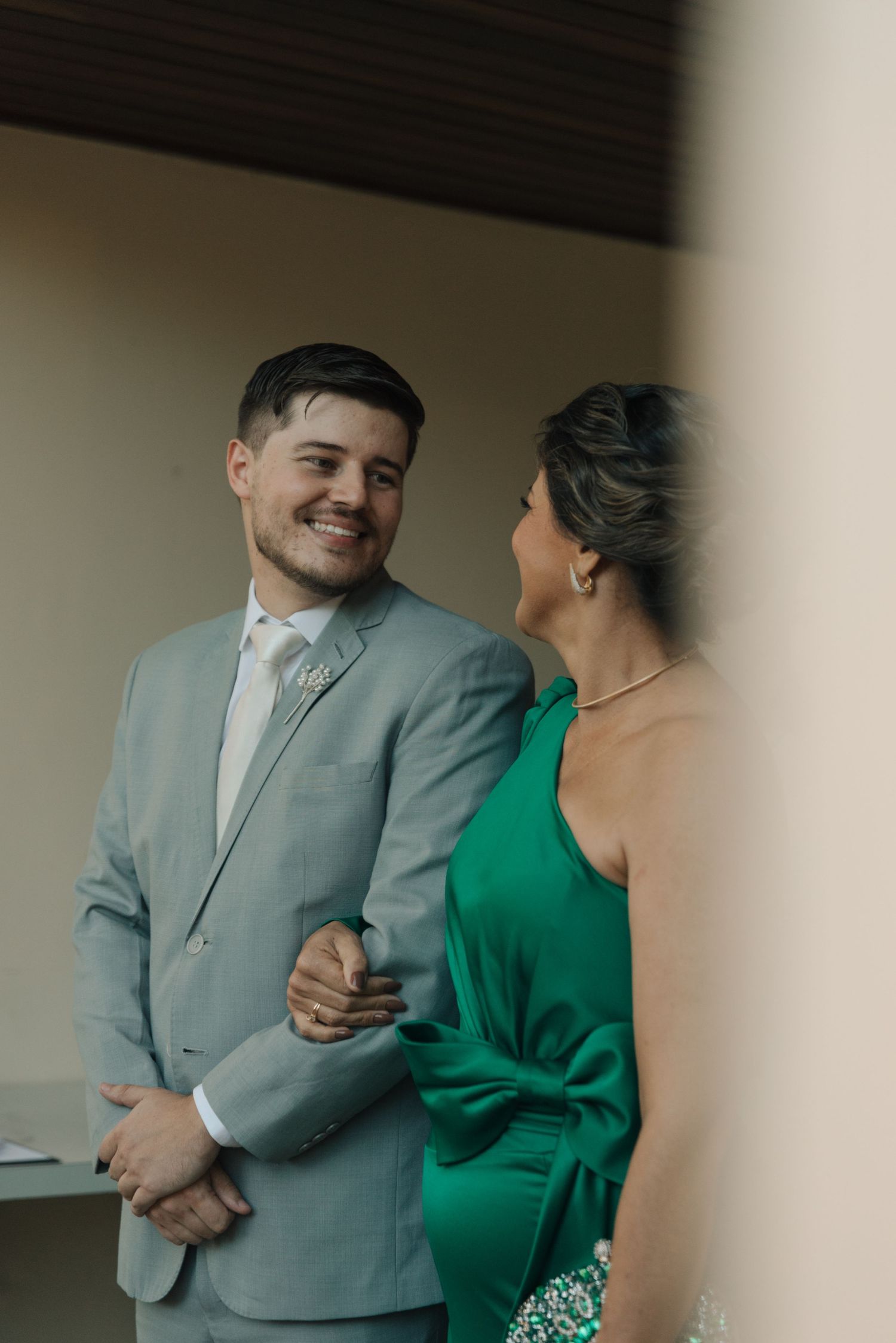 Candid moment captured between wedding party members in formal attire.